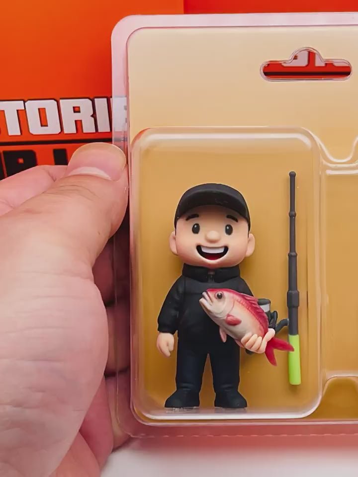 Video showcasing a custom-made 3D figurine of a fisherman with his catch, in its clear retail packaging for personalized gifts.
